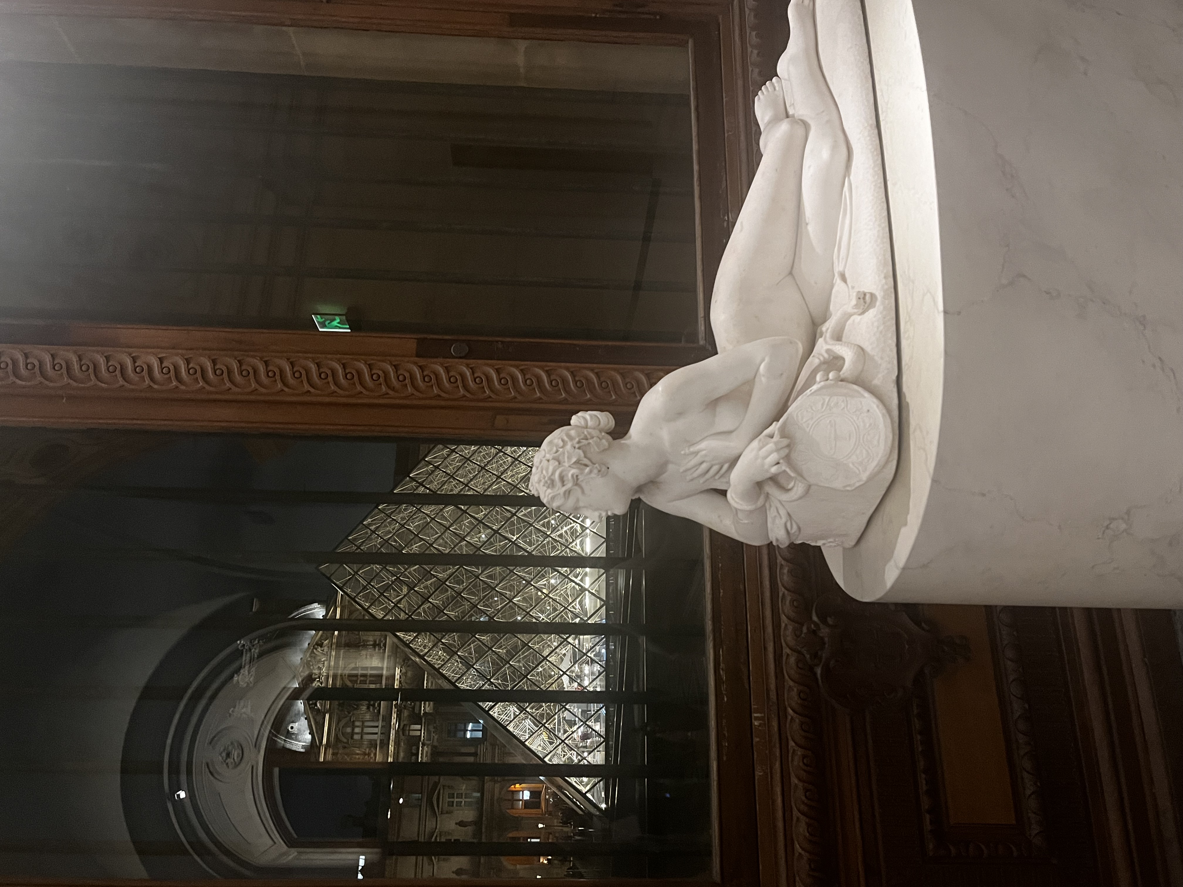 Louvre sculpture gallery and pyramid at night